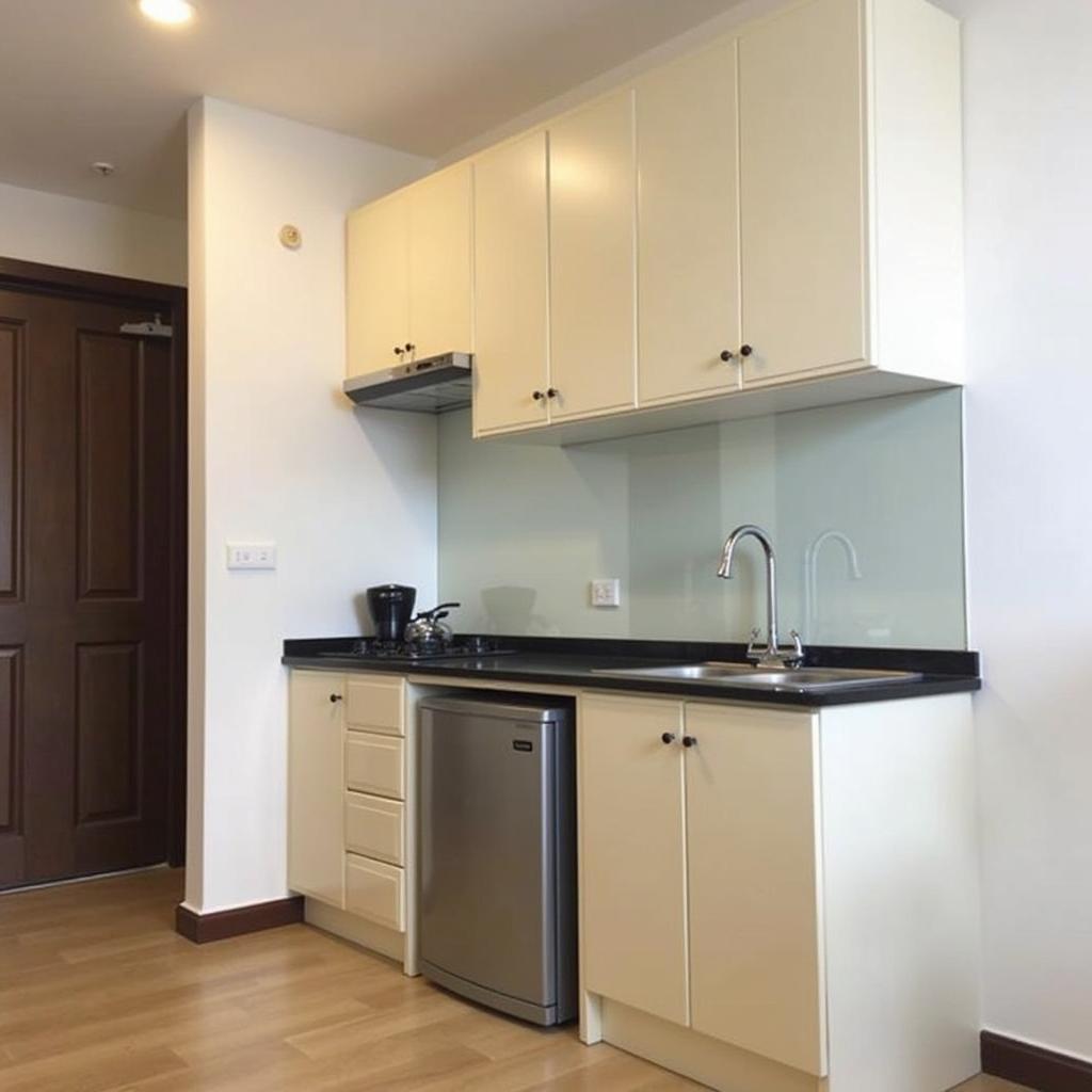 Không gian tiện nghi bên trong căn hộ dịch vụ Lam Hồng Hotel, nổi bật với khu vực bếp nhỏ và phòng khách thoải mái.