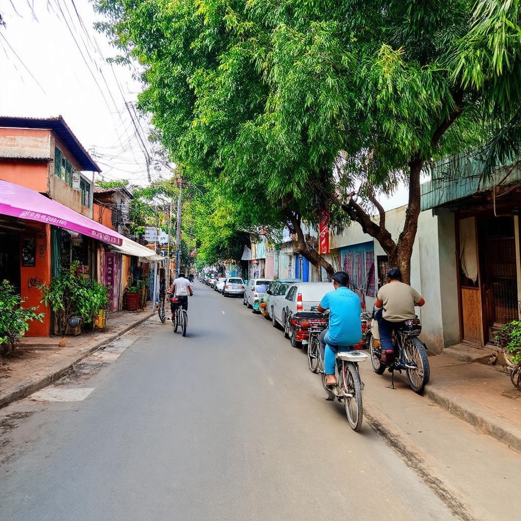 Một góc đường Phạm Văn Đồng ở Hội An với hàng cây xanh mát và phương tiện di chuyển nhộn nhịp gần December Hội An Villa