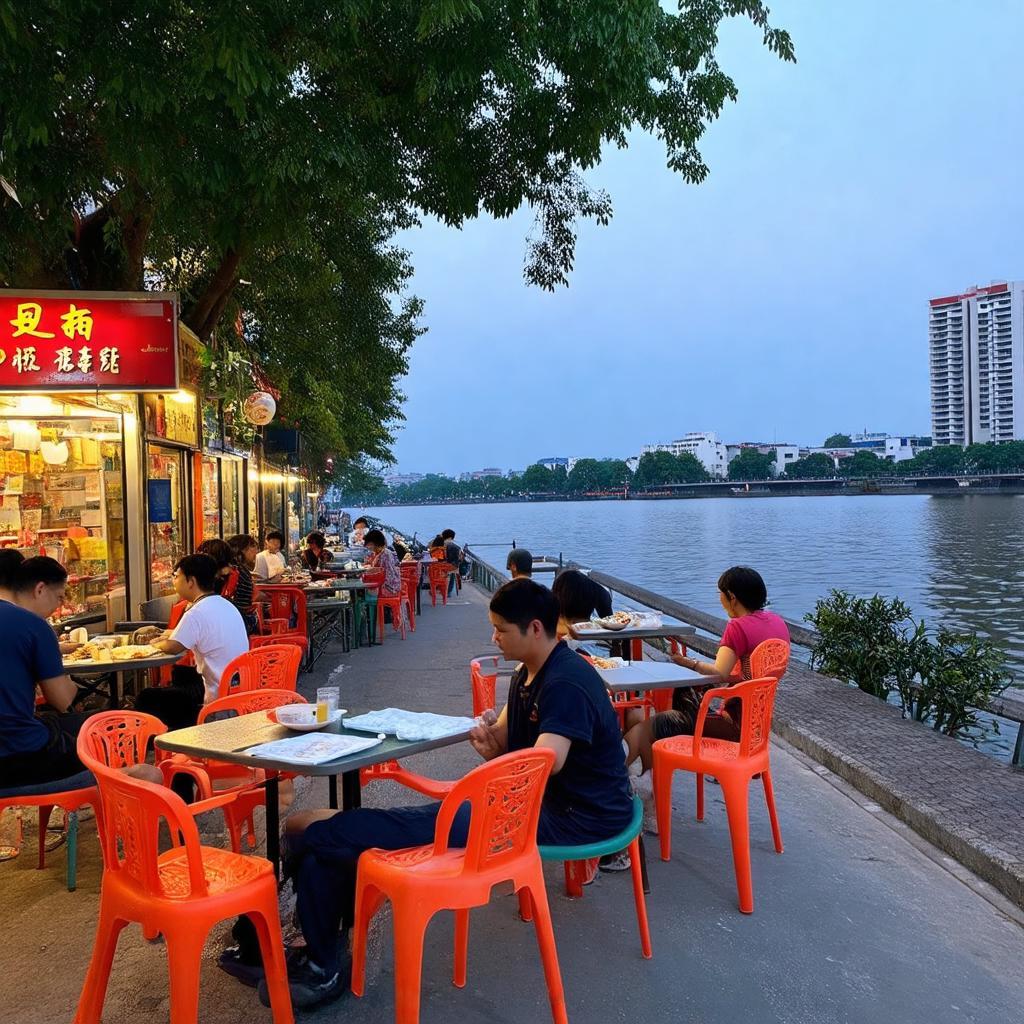 Không gian quán ốc vỉa hè giản dị với bàn ghế thấp, hướng ra hồ Tây lãng mạn tại 167 Trích Sài.