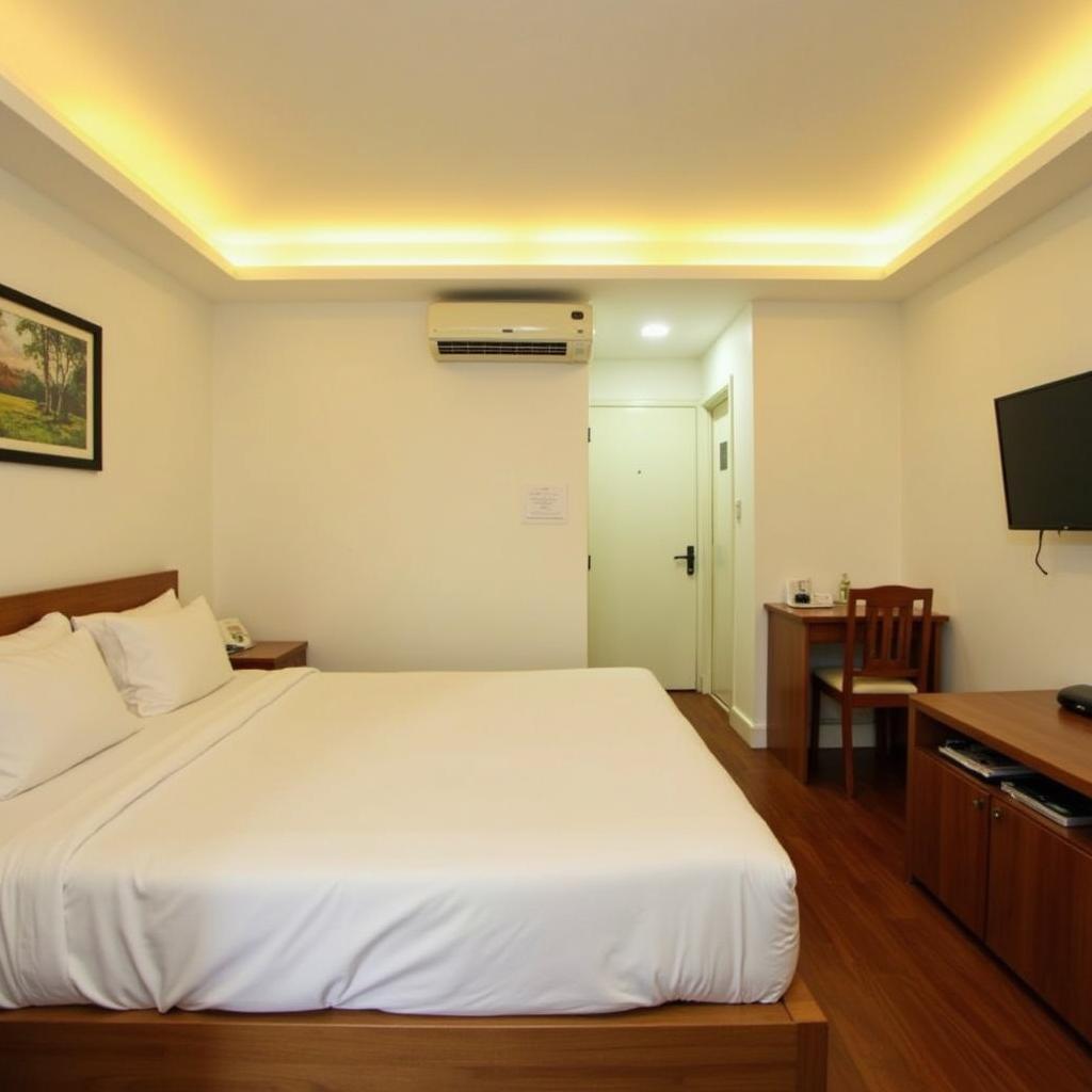 Nội thất bên trong một phòng nghỉ tiêu chuẩn sạch sẽ và ấm cúng tại khách sạn Vạn Lộc Cần Thơ.