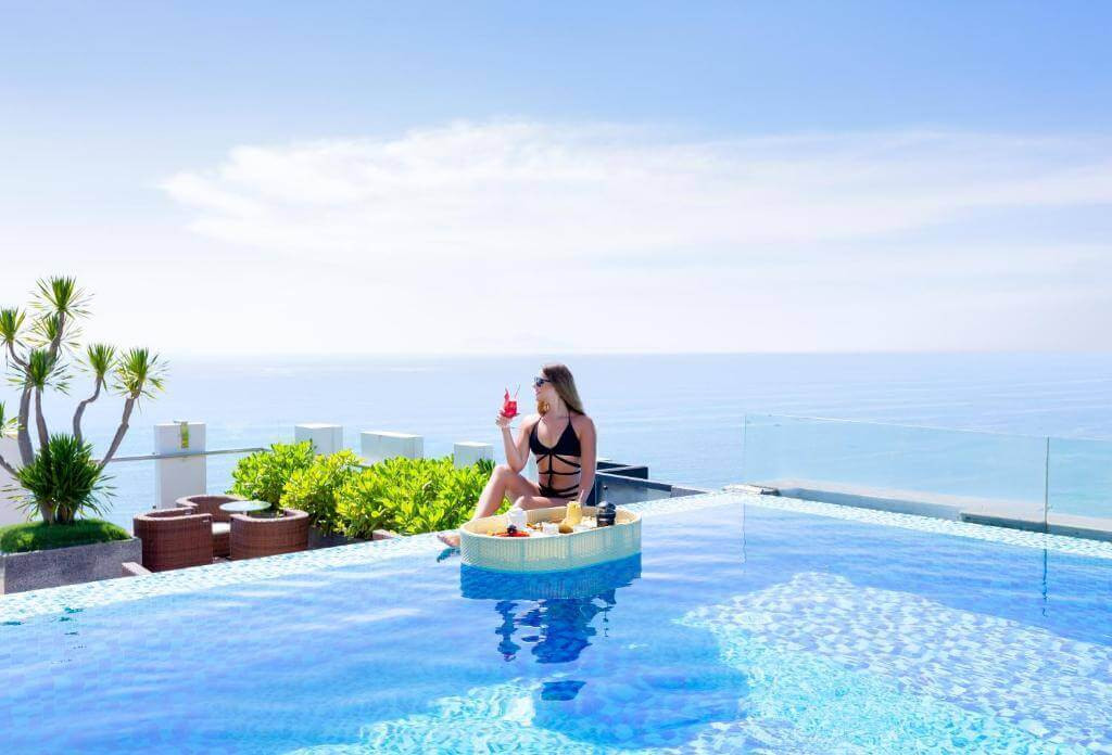 Du khách thư giãn tại bể bơi vô cực của HAIAN Beach Hotel, tận hưởng bữa sáng nổi độc đáo và tầm nhìn trực diện ra biển Mỹ Khê.