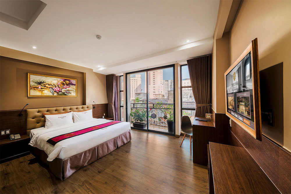 Phòng ngủ rộng rãi tại khách sạn SUNFLOWER CBQ HOTEL với giường lớn, nội thất hiện đại và cửa sổ đón ánh sáng tự nhiên, mang đến không gian nghỉ ngơi thoải mái tại khách sạn 3 sao quận 1 SUNFLOWER CBQ HOTEL